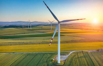 wind turbine at a field in sunset